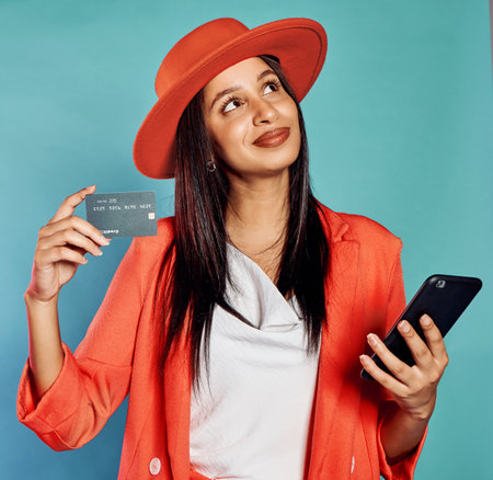 Credit card, online shopping and trendy woman with style typing in banking information to use a...