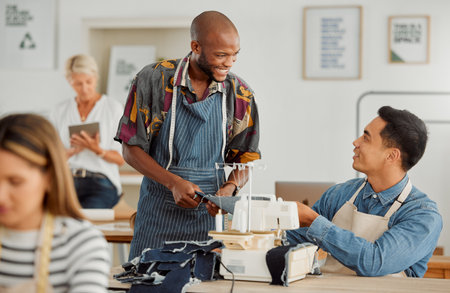 Fashion designers, colleagues and men sewing clothes in a workshop. Happy, diverse and smiling young creatives planning garment designs in a textile, clothing and manufacturing studio or factoryの写真素材