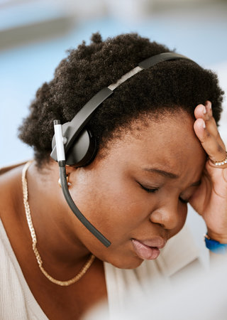 Burnout, headache and stressed female call center agent working with problem, bad mental health or...