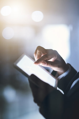 Connect to success. a businesswoman using a digital tablet during a late night at work.