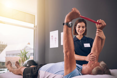 Im impressed. a young female physiotherapist treating a mature male patient.