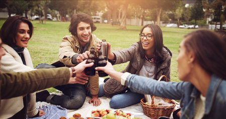 Fun with friends. young friends having a picnic outside.の写真素材