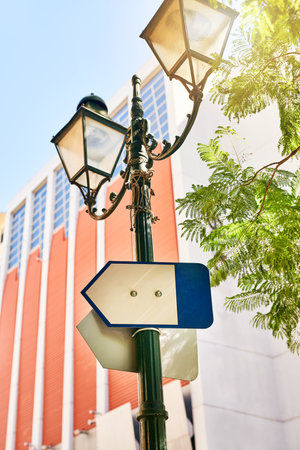 You will never loose direction here. a directional sign on a streetlamp outside during the day.の写真素材