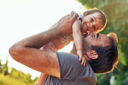 Daddy will never stop loving you. a young father with his little girl outdoors.の写真素材