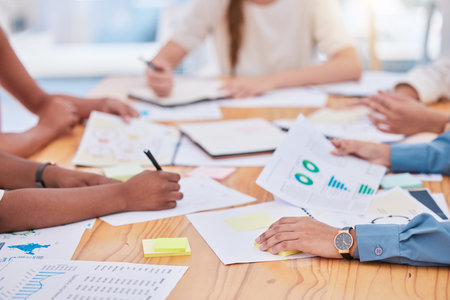 Project management, budget and schedule planning with business people hands in meeting closeup and paper work or document analysis. Marketing team or company looking at graphs, charts and seo dataの写真素材