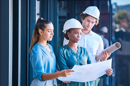 Engineer, architect or designer team looking at blueprint, design layout paper for construction...