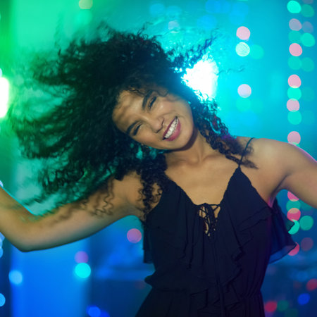 Shes got some moves. a beautiful young woman dancing in a nightclub.