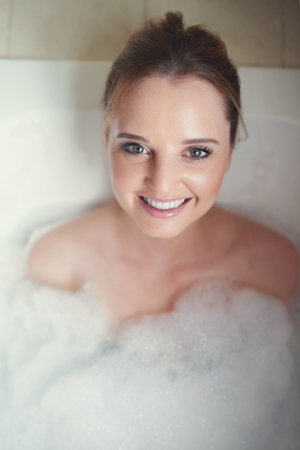 How I like to unwind after a long week. Portrait of an attractive young woman relaxing in the...
