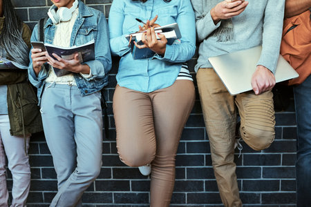 They stay connected. a. group of unrecognizable university students standing in a campus corridor.の写真素材