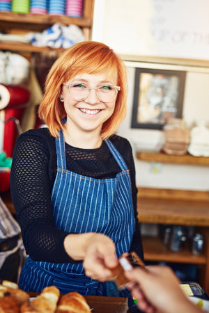 We now accept card payments. an unrecognizable man paying for his purchase by card.の写真素材