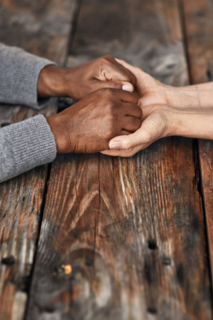 Let me be your rock. High angle shot of an unrecognizable senior couple holding hands in comfort outside.の写真素材