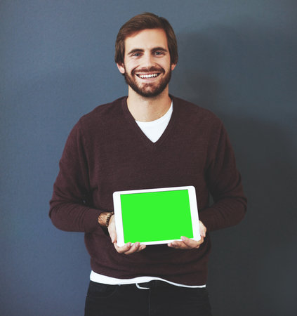 Ive been telling everyone about this. Studio portrait of a young man holding a digital tablet...