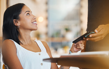 Tap to pay, customer phone and mobile nfc payment for digital transaction, money transfer and cashless sale in a cafe store. Woman paying for ecommerce, service and fintech in hospitality restaurantの写真素材