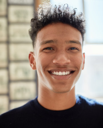 Hes an easygoing kinda guy. Portrait of a confident young man standing indoors.の写真素材