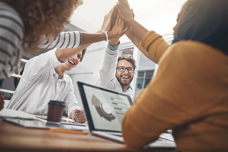 We know we can depend on each other. colleagues high-fiving in the office.