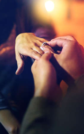 This is a big step. High angle shot of an unrecognizable man proposing to his girlfriend over dinner.の写真素材