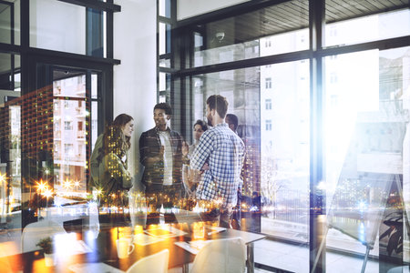 Great minds at work. Multiple exposure shot of businesspeople superimposed over a cityscape.