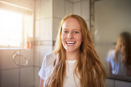 Feeling fresh and clean, ready for the day. a young woman at home.の写真素材