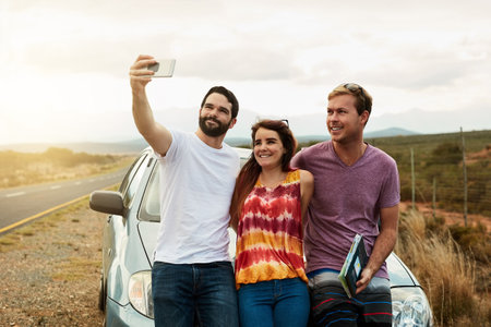 Lets take our first photo together for the trip. a group young friends getting in close or a self...