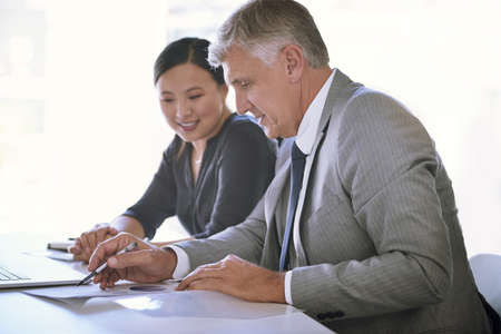 Enthusiasm meets experience. a team of businesspeople meeting at a table in the boardroom.