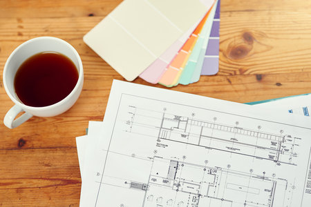 Design essentials for the creative entrepreneur. High angle shot of coffee, blueprints and color...