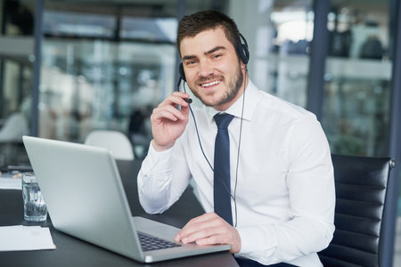 Here to offer support. Portrait of a young customer service representative wearing a headset while...