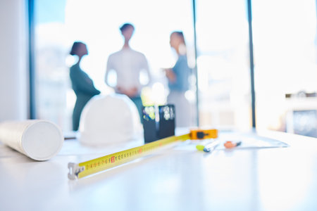 Creative engineering designer discuss building plans in a corporate business. Measure tape on a...
