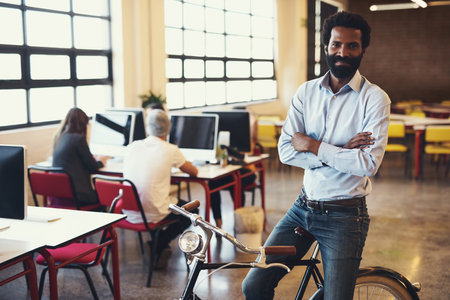 The best way to move around the office. a handsome man on a bicycle in a modern office.
