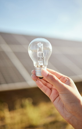 Mockup of hand with light bulb for solar energy in nature, sustainability for green change and clean energy for future environment. Research in sustainable industry and innovation with electricityの写真素材