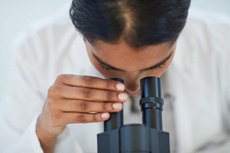 The answers are all in the details. a young female scientist working in a lab.の写真素材