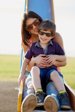 The park is our happy place. Portrait of a mother and son enjoying a day at the park together.の写真素材