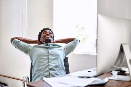 Ending off another productive day. a young designer taking a break at his office desk.