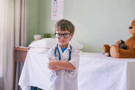 Allow your child to develop his own interests. an adorable little boy dressed as a doctor.の写真素材