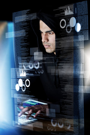 Hes a true night owl. a young hacker cracking a computer code in the dark.