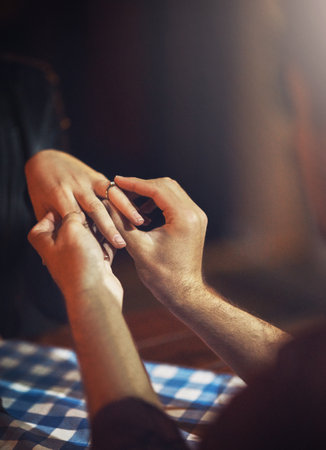Im making her m wife. a man putting an engagement ring onto his fiancees finger.の写真素材