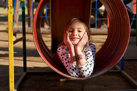 Where childhood memories are made. Portrait of a little girl playing in a park.の写真素材