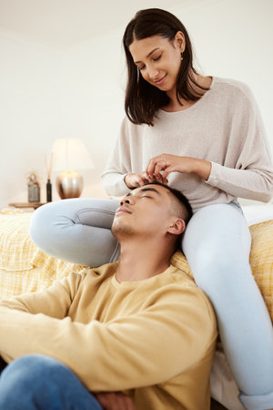 Romantic, in love and relaxed couple relaxing together in a lovely, cute and peaceful home romance...