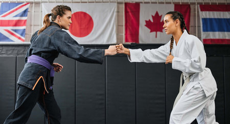 Women, martial arts and karate at a dojo for workout, exercise or health or aikido and fitness. Taekwondo, fighting and sports training people at the gym for a fight or international competition.の写真素材