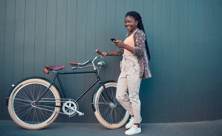 Girl, relax with bicycle and using smartphone app, social media and doing a internet or web search....