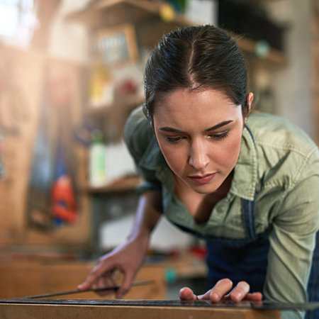 Shes a perfectionist. a young female designer in her workshop.