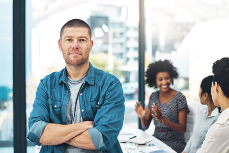 Dream big and achieve bigger. Portrait of a mature businessman standing in an office with his...