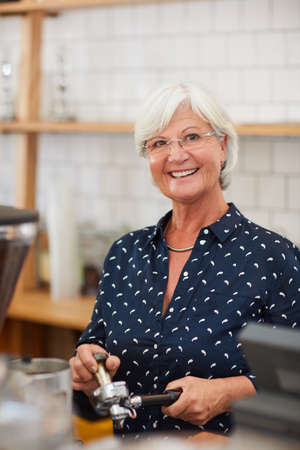 When its your passion, its not a job. Portrait of a senior woman working in a coffee shop.