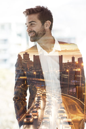 Well-suited to success. a handsome young businessman superimposed on a cityscape.の写真素材