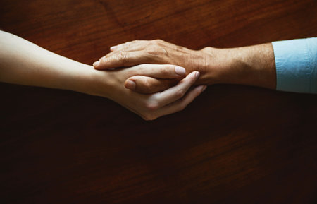 Help will always be within reach. Closeup shot of two unidentifiable people holding hands in comfort.の写真素材