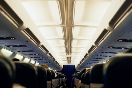 Ready for a change of scene. Rearview shot of unidentifiable passengers seated in an airplane cabin.の写真素材