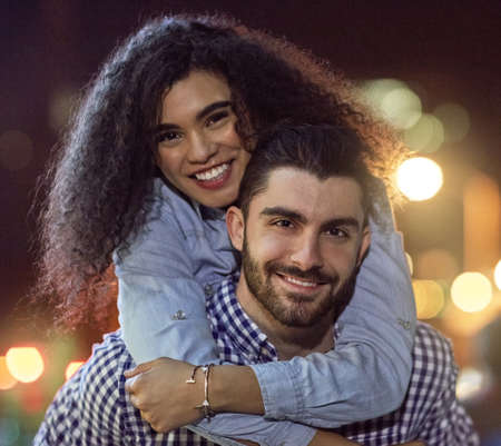 Love makes us lighthearted. Portrait of an affectionate young couple out on a date in the city.の写真素材