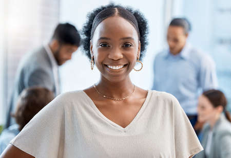 Business woman with smile at company office, leadership of teamwork and happy of planning for success at work. Portrait of face of a manager, employee or worker working in meeting and collaborationの写真素材