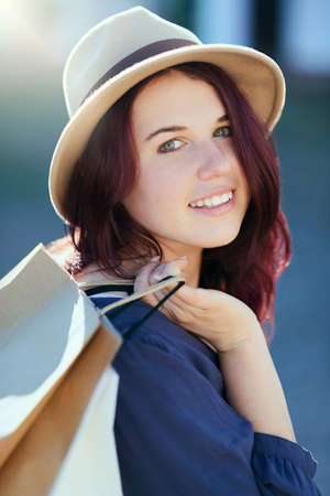 Ive picked up so many bargains today. Portrait of a beautiful young woman out on a shopping spree in...