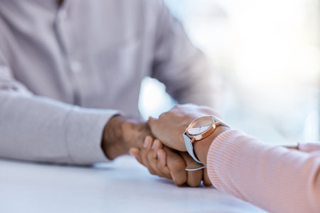 Cancer, trust and support holding hands, woman showing compassion and kindness after bad news. Female comfort male health crisis after results or diagnosis. United people show affection in hard timeの写真素材