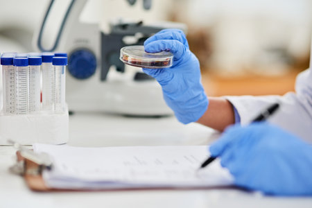 The answers lie within the details. Closeup shot of a scientist examining a sample in a petri dish...